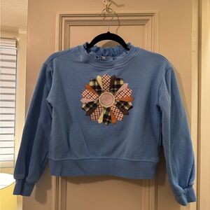 Copper Key Blue Girls’ Sweater with Ruffle Neckline and Plaid Flower Accent